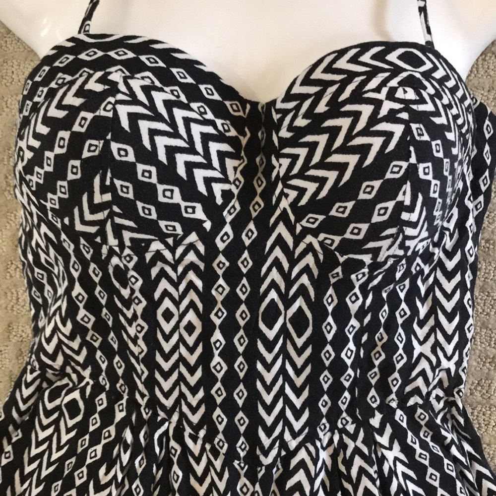 Material girl cream and black romper with bustier style top.